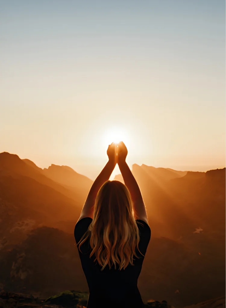 Mãos segurando o sol em um horizonte, representando a expansão da consciência e a metodologia transpessoal.